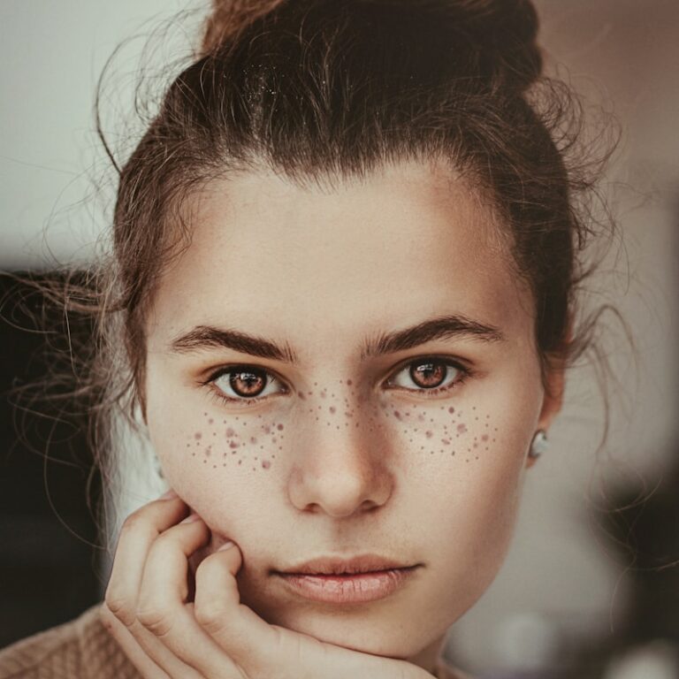 smiling woman holding cheek